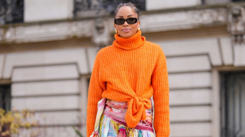 woman wearing orange sweater