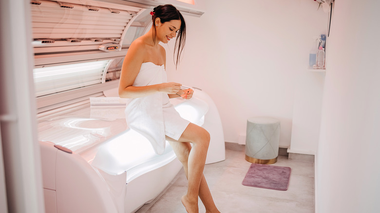 Woman sitting on sunbed