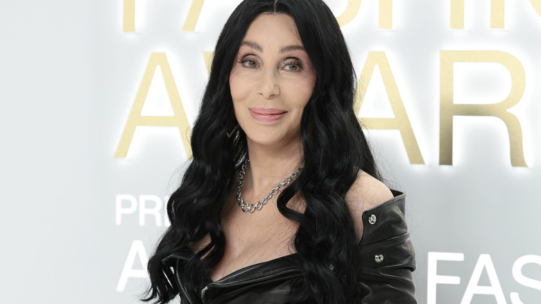 Cher walking a red carpet