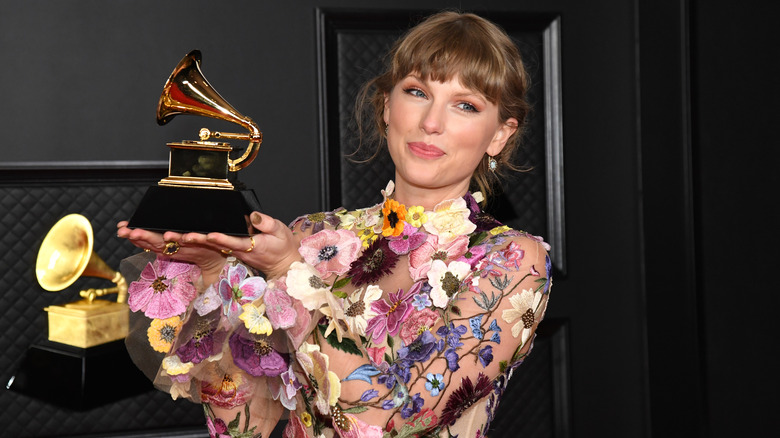 Taylor Swift holding Grammy Award