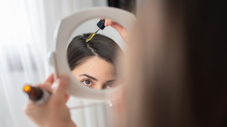 girl applying tea tree oil