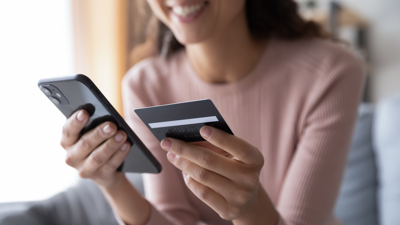 happy woman doing transaction on phone