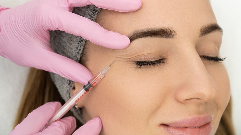 woman getting injection near eye