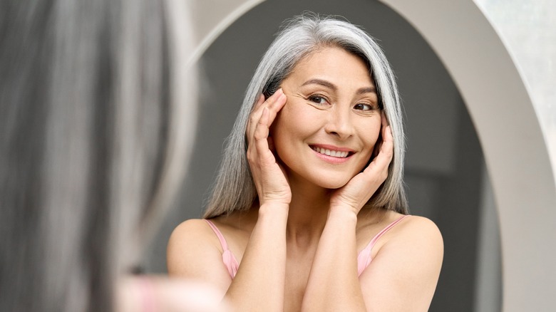 happy middle aged woman in mirror