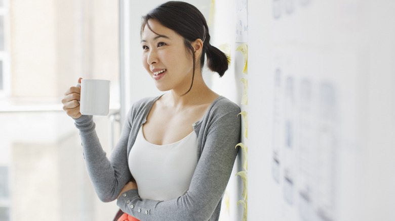 smiling woman with cup of coffee