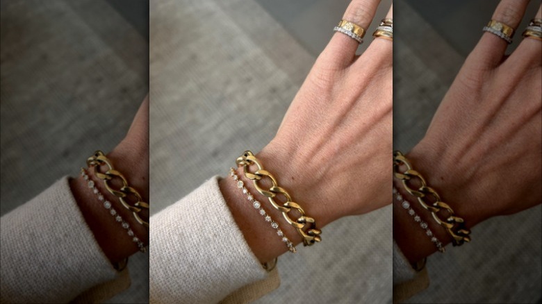 Woman wearing two bracelets, rings