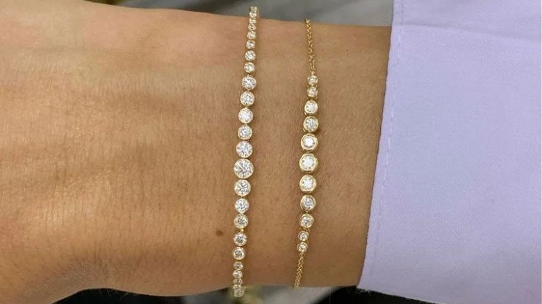 Woman wearing two tennis bracelets