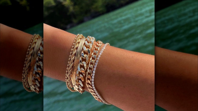 Woman wearing multiple gold bracelets