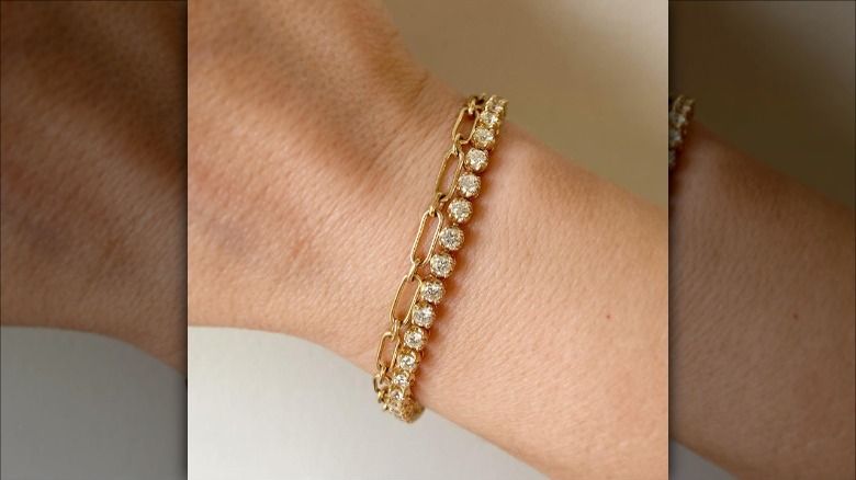 Woman wearing gold, tennis bracelets