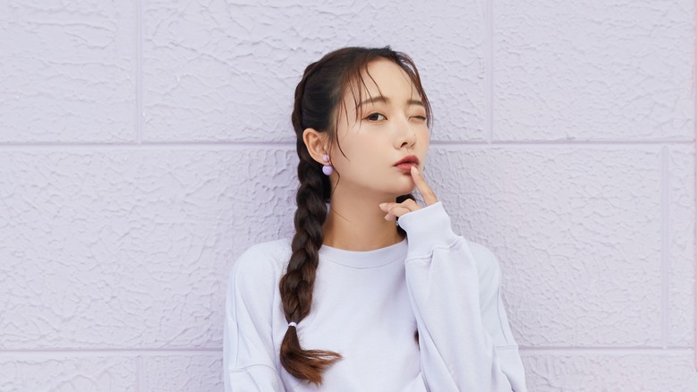 Woman in pigtails lilac sweatshirt