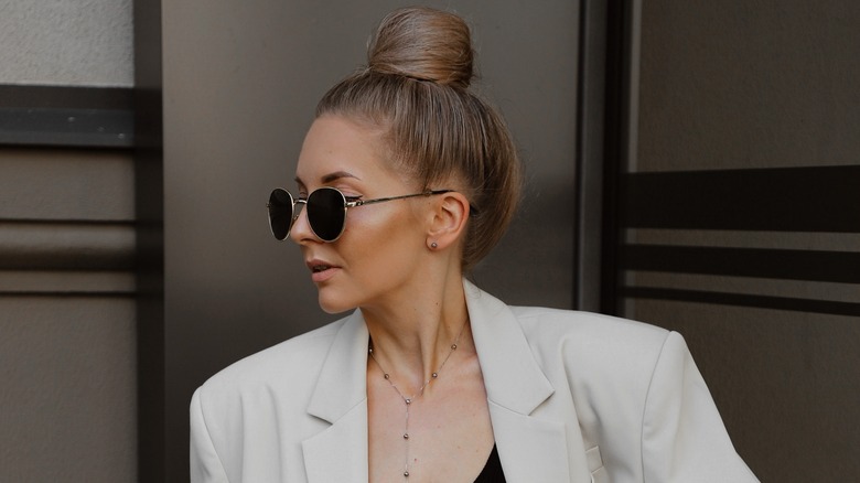 Woman with top bun beige blazer