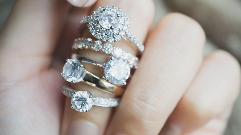 Engagement rings stacked on finger