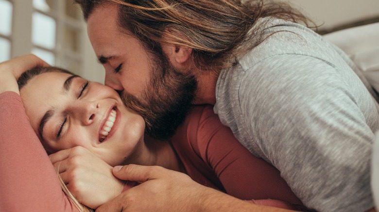 Man kissing woman on cheek