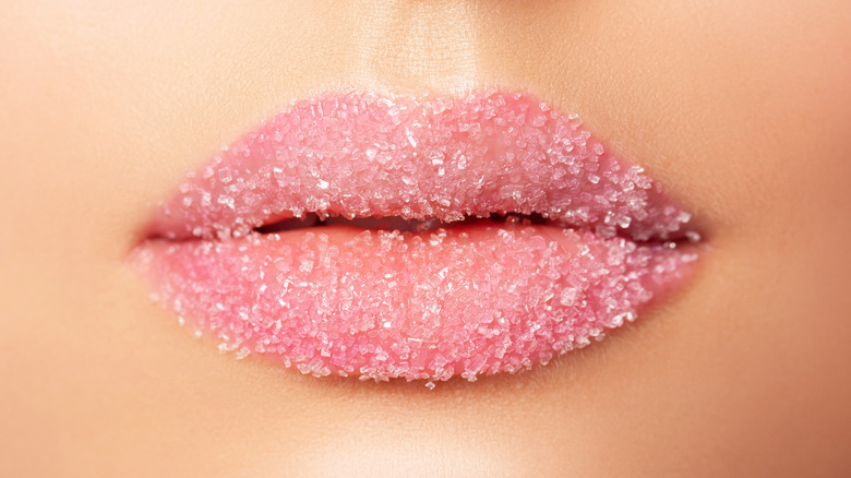 Woman's lips coated in sugar scrub