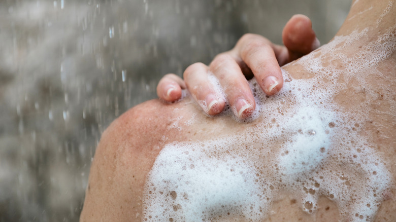 Foamy soap on person's back