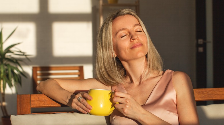 Peaceful woman drinking coffee