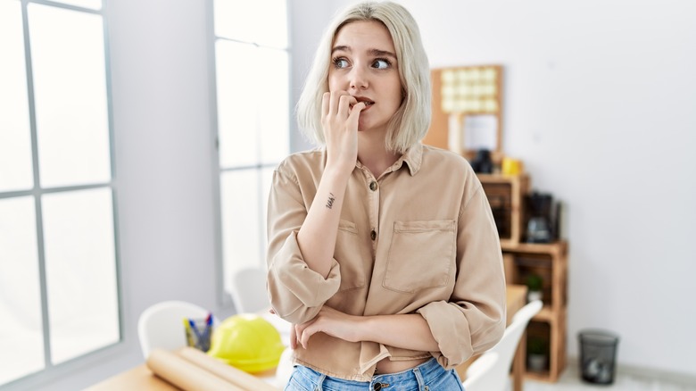 Nervous woman biting nails 