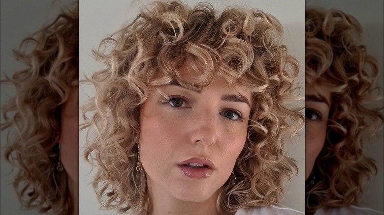 woman with curly bangs and bob haircut