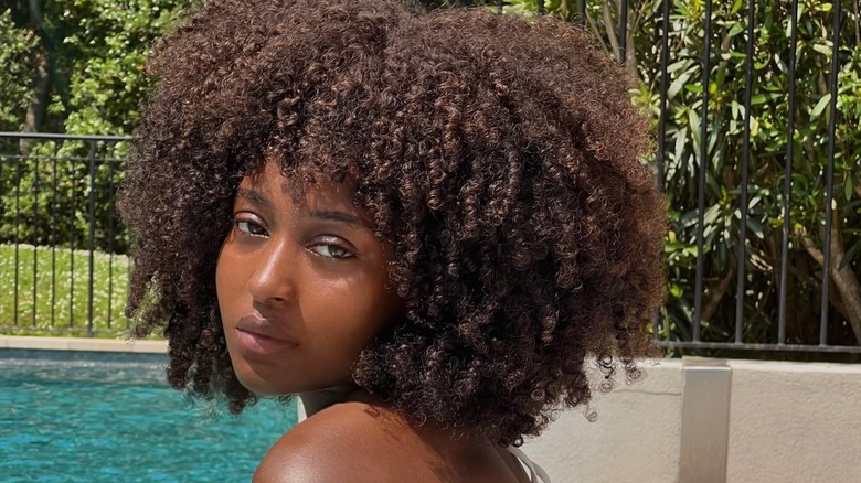 woman with afro and curly bangs