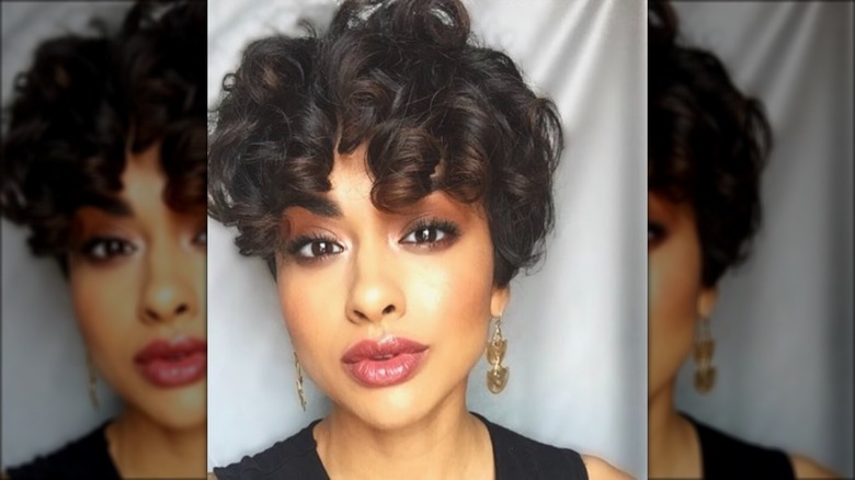 woman with curly bangs pixie cut