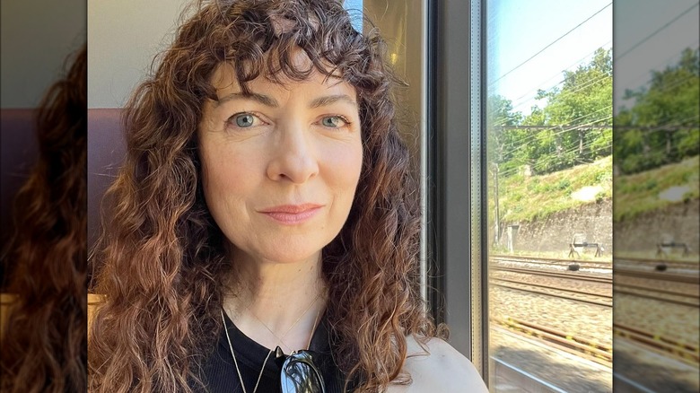 woman with straight cut curly bangs