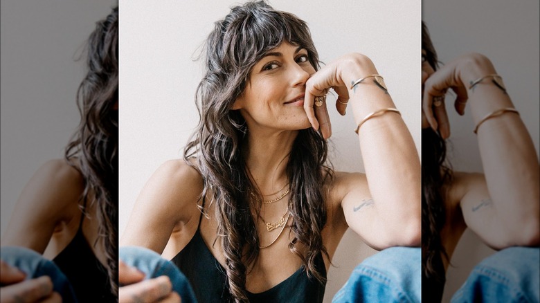 woman with curly hair and bangs