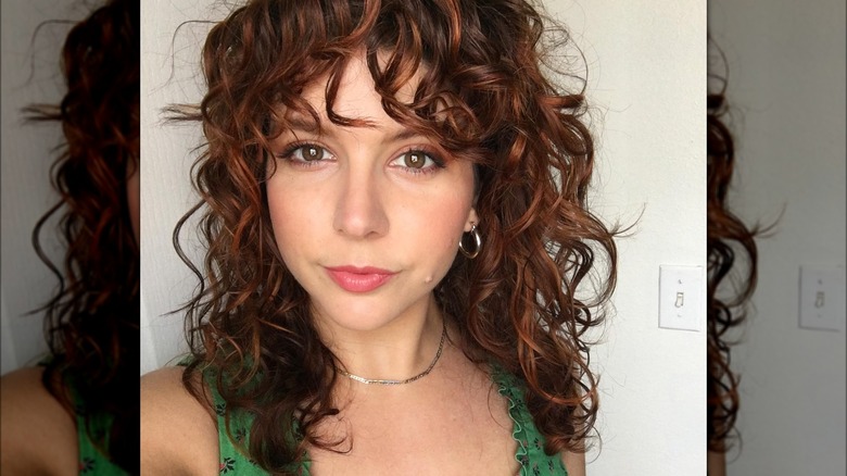 woman with curly layered bangs