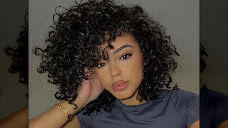 woman with curly hair sideswept bangs