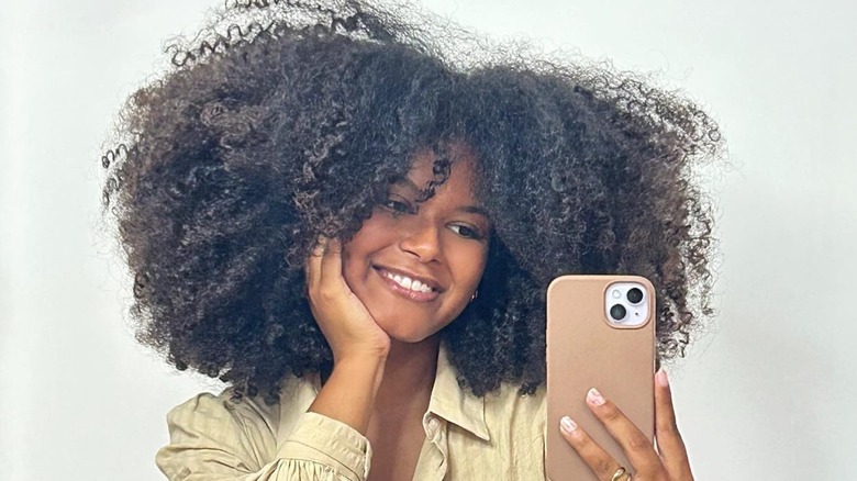 woman with straight cut bangs afro