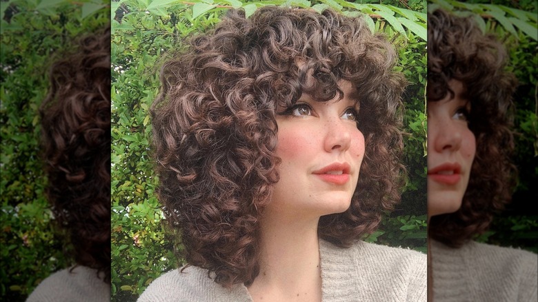 woman with curly hair bob and bangs