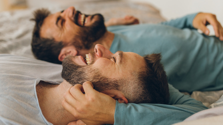  couple laughing on bed