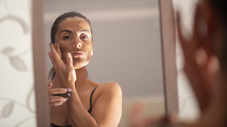 Woman exfoliating with coffee