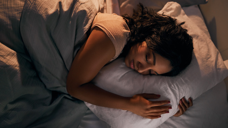 Girl hugging pillow while sleeping