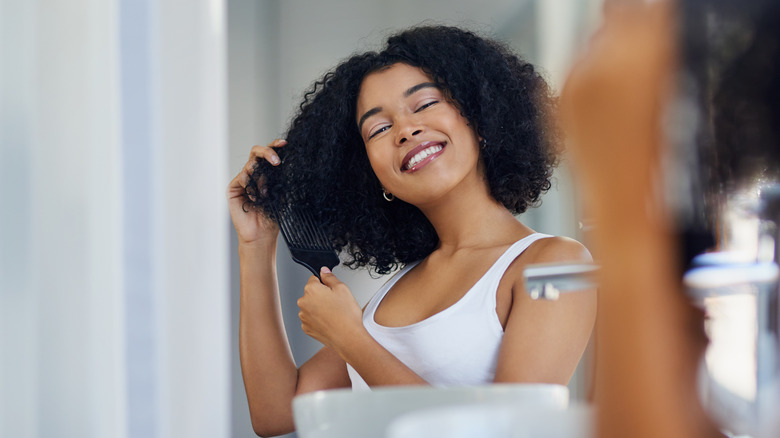 Smiling woman with curly hair pick