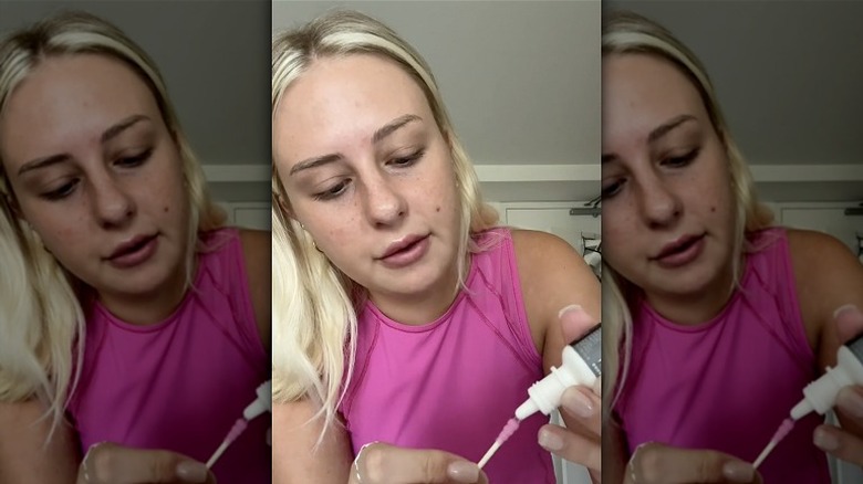 woman applying eye drops to Q-tip