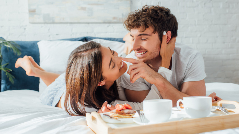 Couple enjoying breakfast in bed