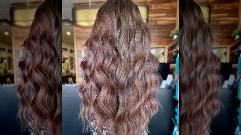 Woman models balayage with rose gold highlights