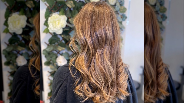 Woman models golden blond balayage 