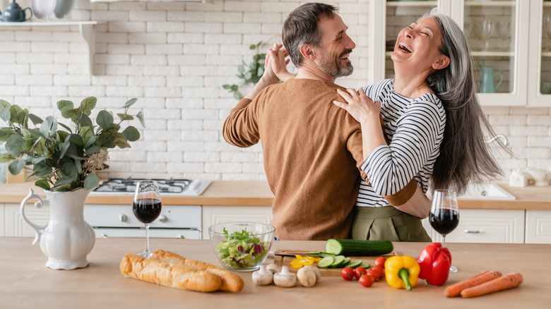 man and woman dancing in the kitchen