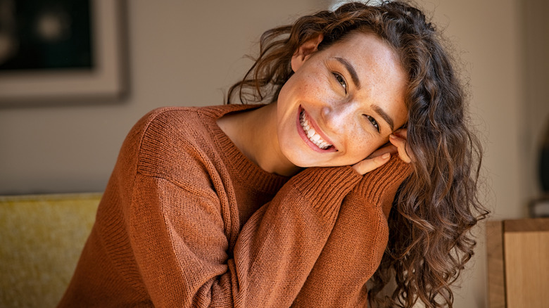 woman with curly hair smiling