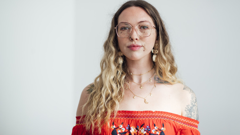 Boho woman with freckles and glasses