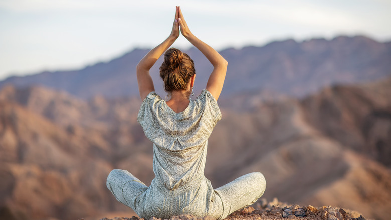 Woman doing yoga in the desert 