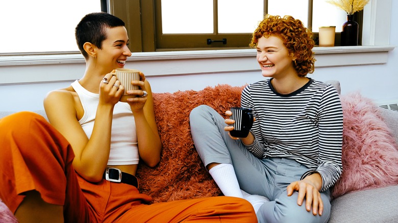 couple on sofa laughing