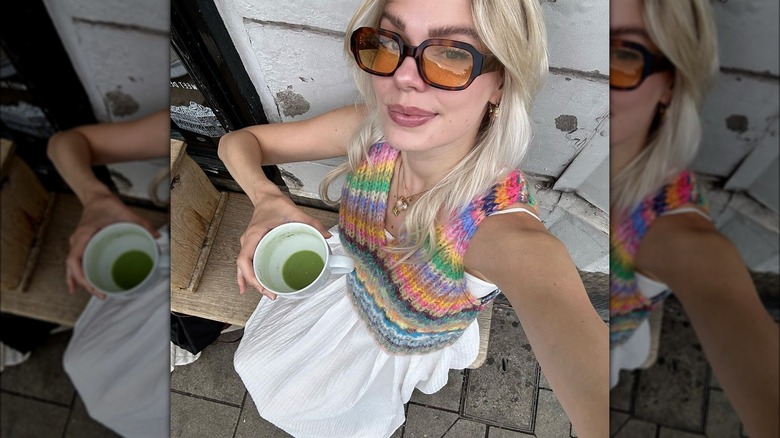 woman wearing flowy white skirt and sweater vest