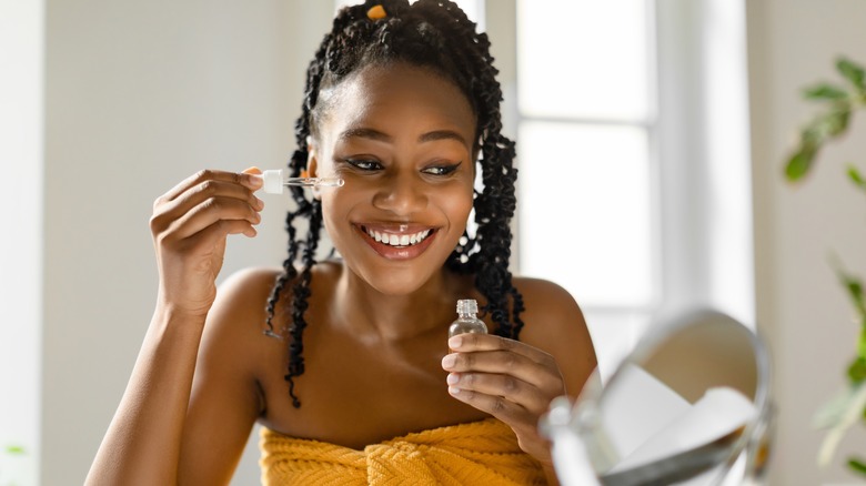 Woman using face serum