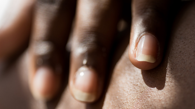 Woman showing bare nails