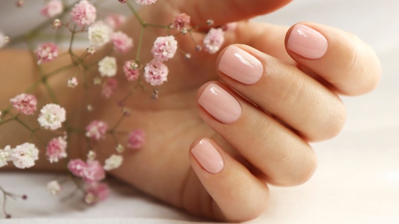 Woman with short pink nails