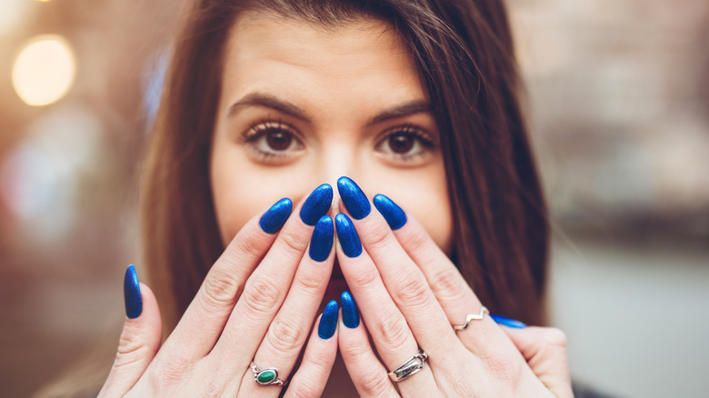 Woman with long blue nails