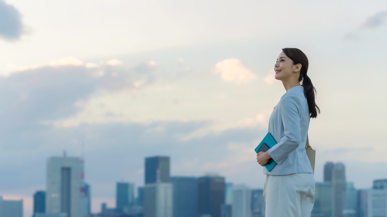 Woman looks at cityscape 