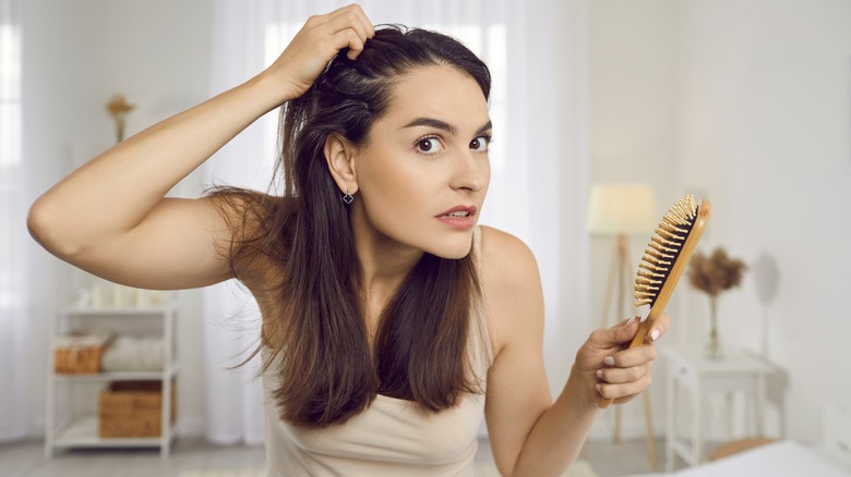 Woman checks for gray hair